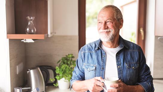 Older Man With Cup Of Tea In Kitchen