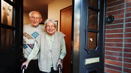 Older Couple Standing At Door