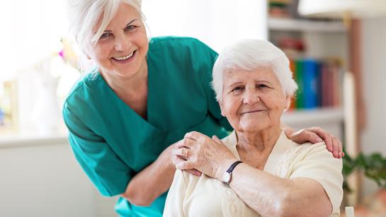 Carer Smiling With Older Woman