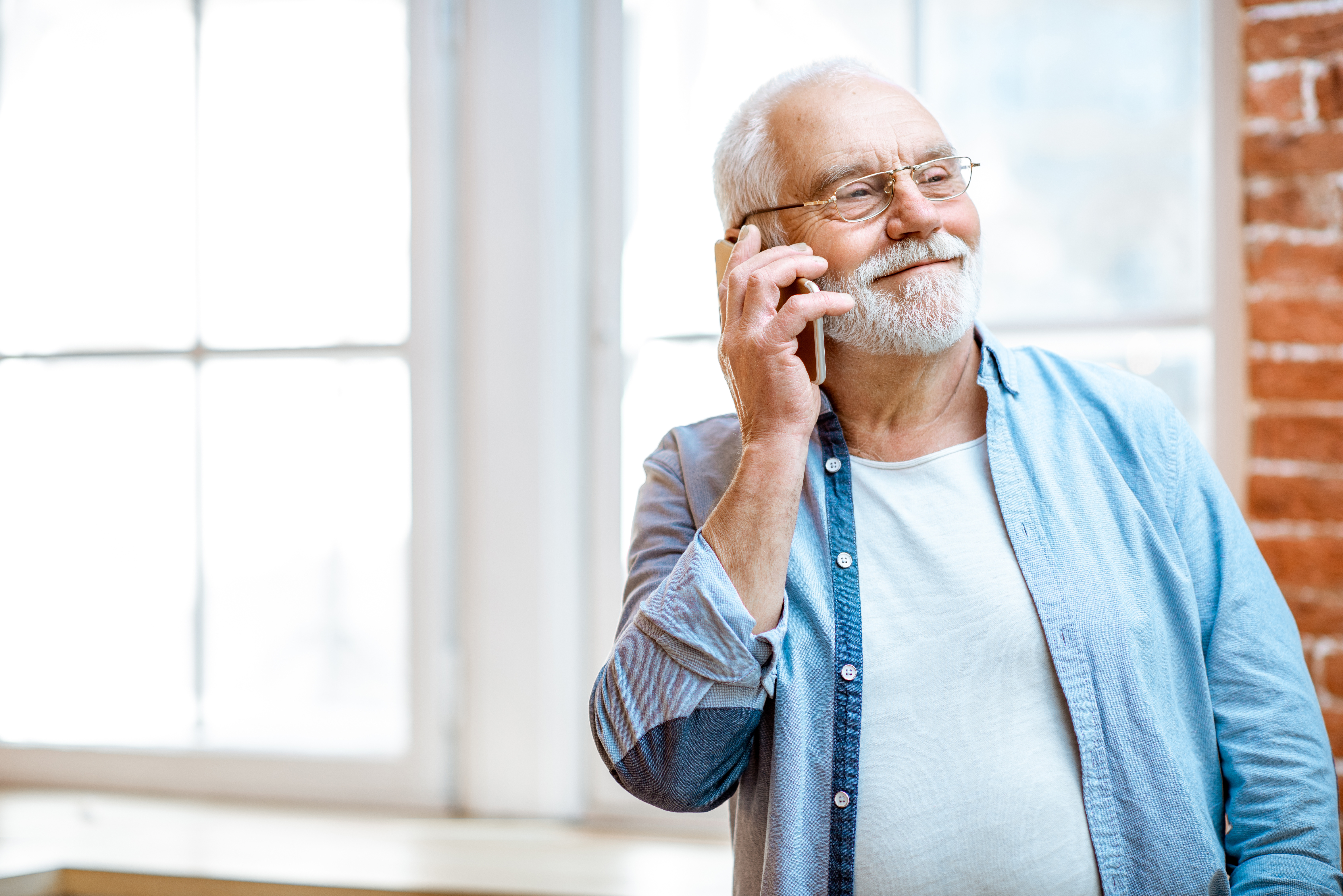 Older man smiling on the phone