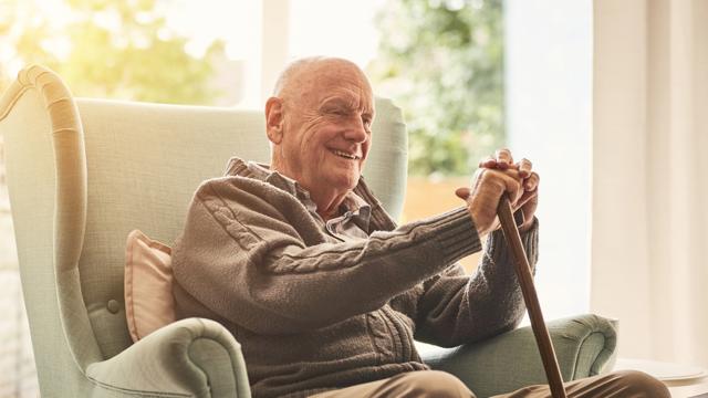 Older Man Sat On His Chair At Home