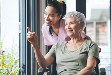 Carer And Older Woman In A Wheelchair