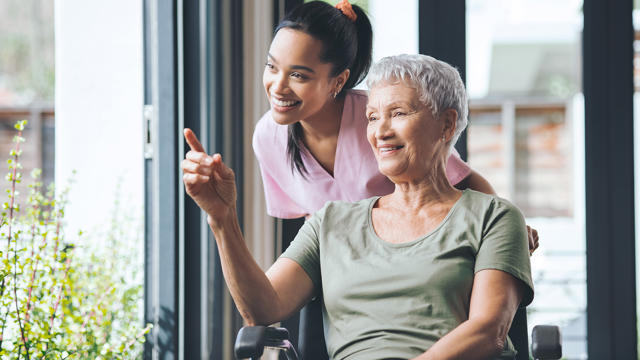 Carer And Older Woman In A Wheelchair