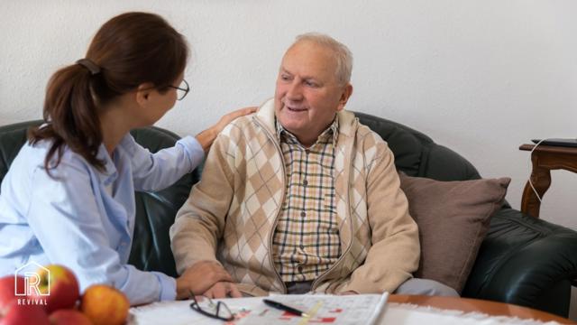 Older Man Sat With A Support Worker