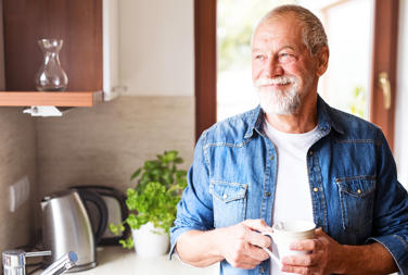 Man In Kitchen With Coffee Cup