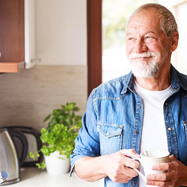 Man In Kitchen With Coffee Cup