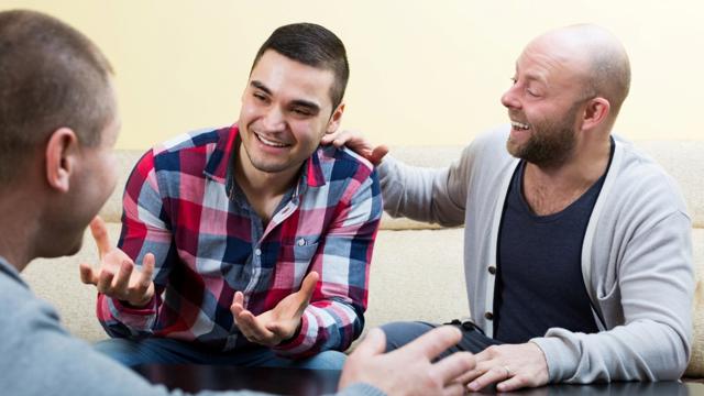 Brothers All Sat Together Talking And Having A Conversation