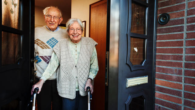 Older Couple Standing At Door