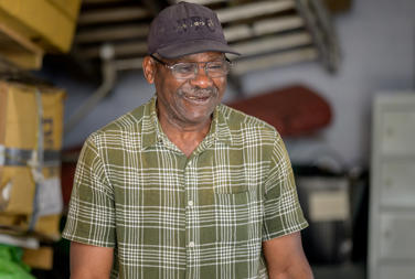 Older Man Smiling At Home In His Garage